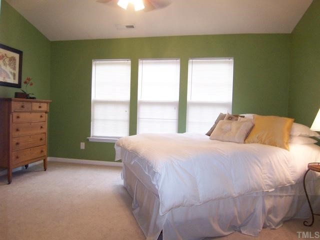 7230 Galon Glen Road Raleigh, NC 27613 - Photo 7 of 12 a bed sitting in a bedroom next to a window
