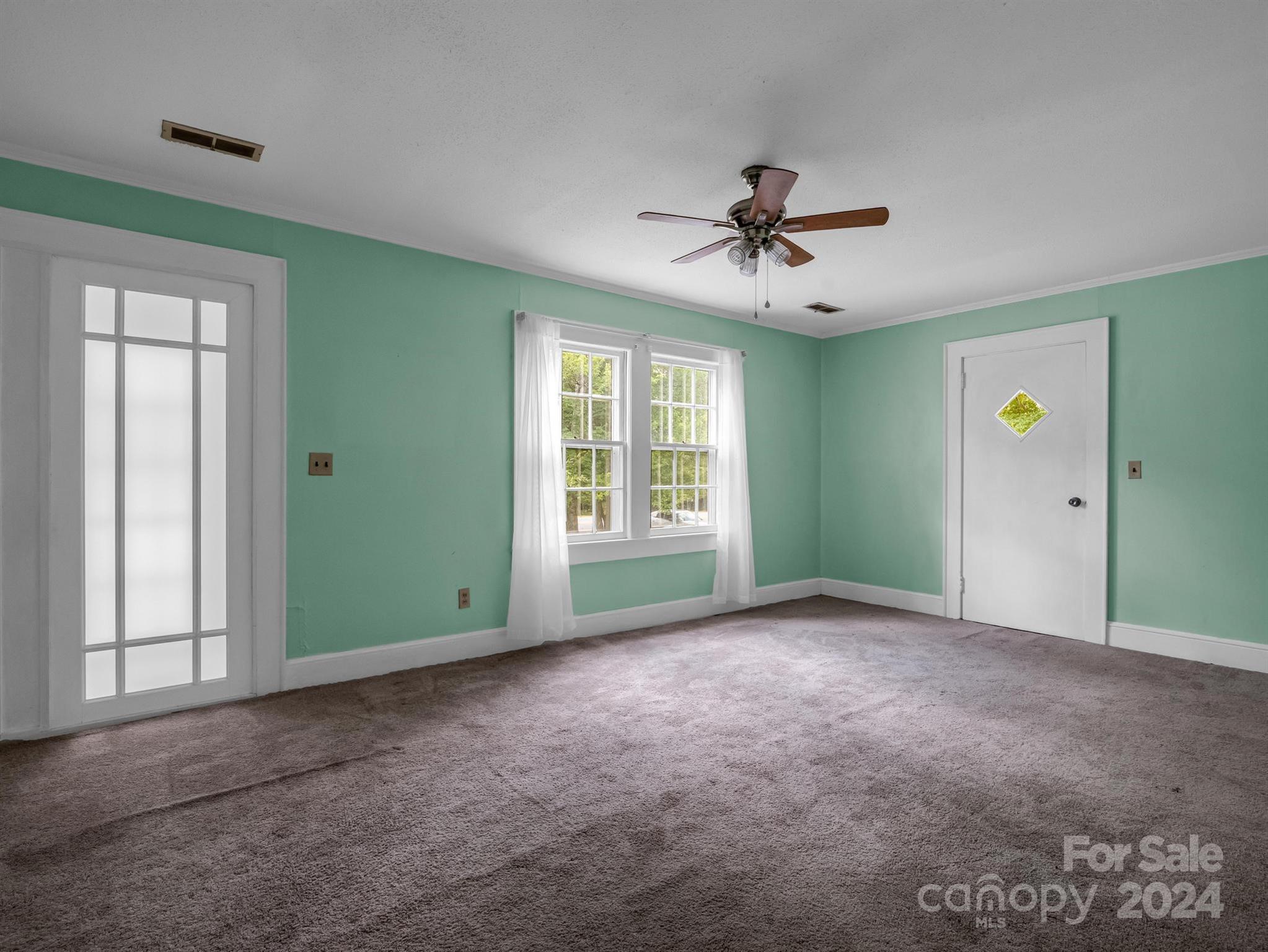 2012 Highway 221 Rutherfordton, NC 28139 - Photo 8 of 24 a view of a livingroom with a ceiling fan and window