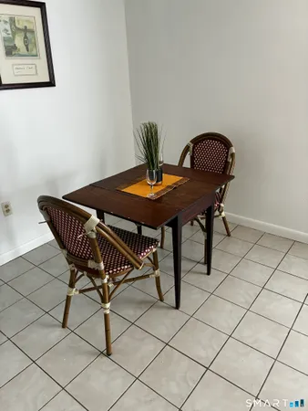 a dining room with a table and chairs