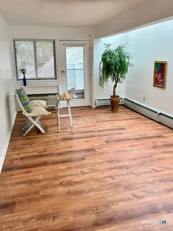 a view of a room with wooden floor and potted plant