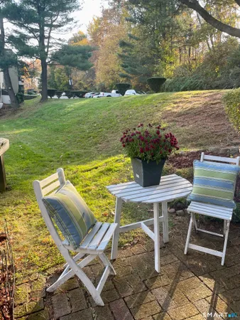 a view of a patio with table and chairs
