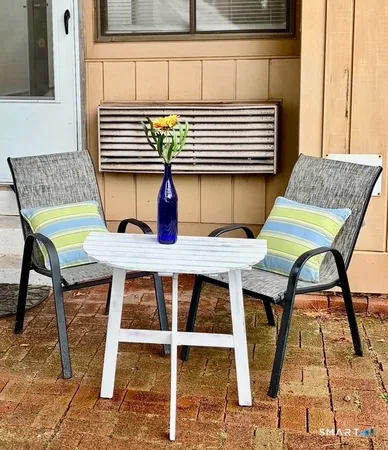 a balcony with table and chairs