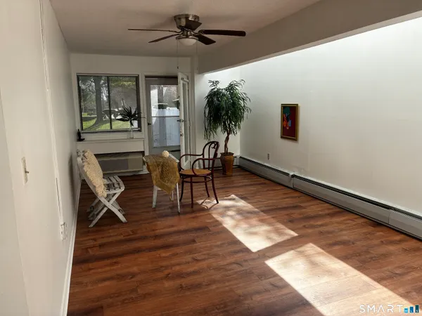 a view of a livingroom with furniture and a ceiling fan