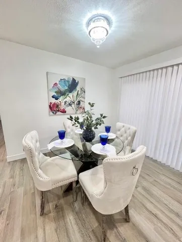 a living room with couches chairs and closet with wooden floor