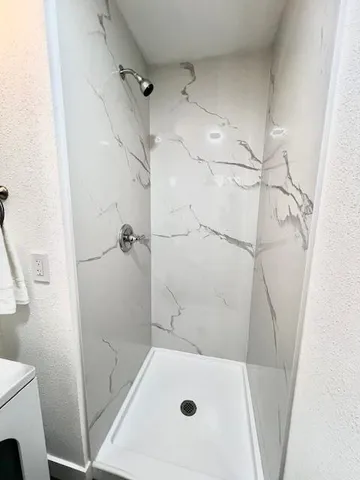 a bathroom with a tub and a shower