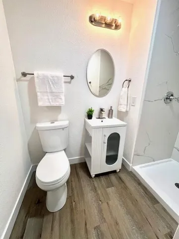 a bathroom with a toilet a sink and a mirror