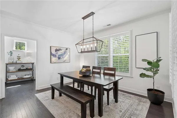 a kitchen with stainless steel appliances kitchen island granite countertop a sink table and chairs