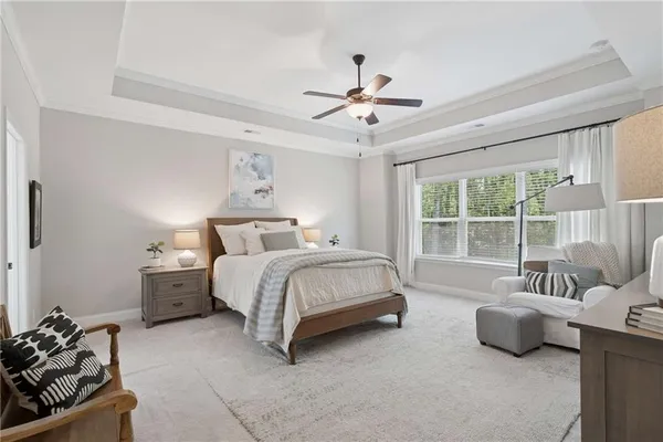 a bedroom with a bed and ceiling fan