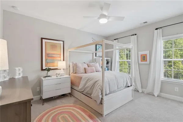 a spacious bedroom with a large bed and a mirror