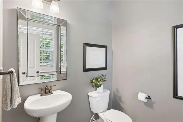 a bathroom with a toilet a sink and a mirror