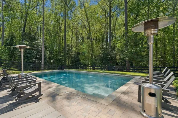 a view of swimming pool with chairs