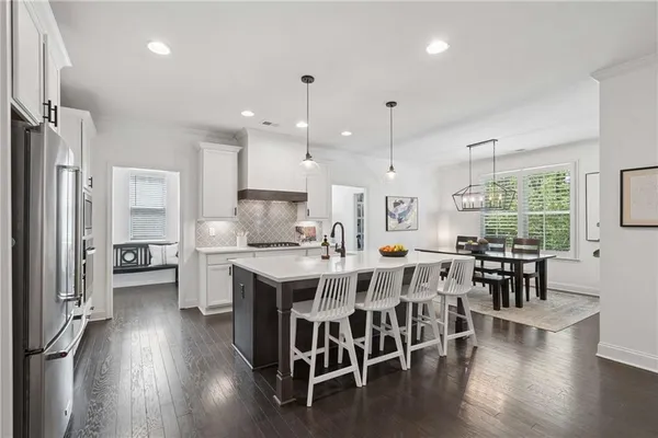 a large kitchen with a table and chairs