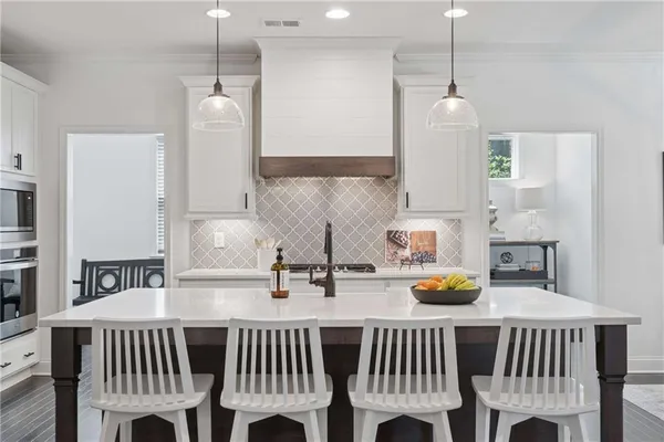 a kitchen with a table chairs sink and cabinets