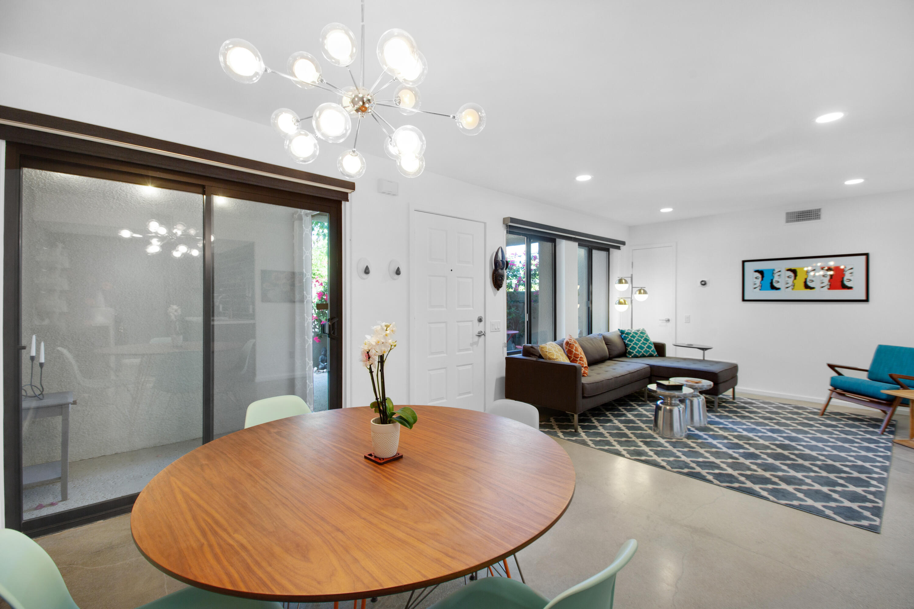 353 North Hermosa Drive, Unit 10A1 Palm Springs, CA 92262 - Photo 13 of 28 a living room with furniture a lamp and a chandelier