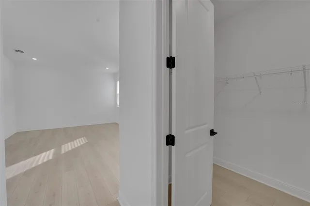 a white kitchen with sink and white cabinets