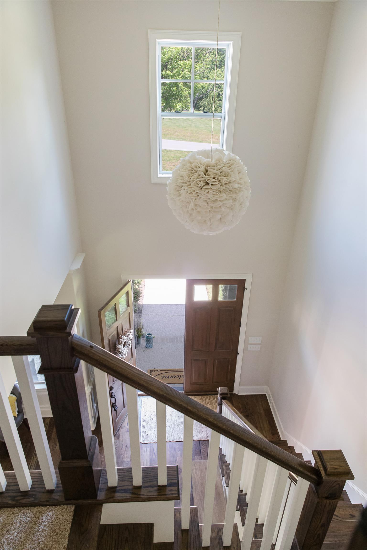 4309 Gallant Ridge Drive Franklin, TN 37064 - Photo 12 of 30 Heading upstairs... Two Story Foyer w Contemporary Lighting. Colors are timeless and wood/trim details are apparent throughout. Solid wood double doors lead to front porch.