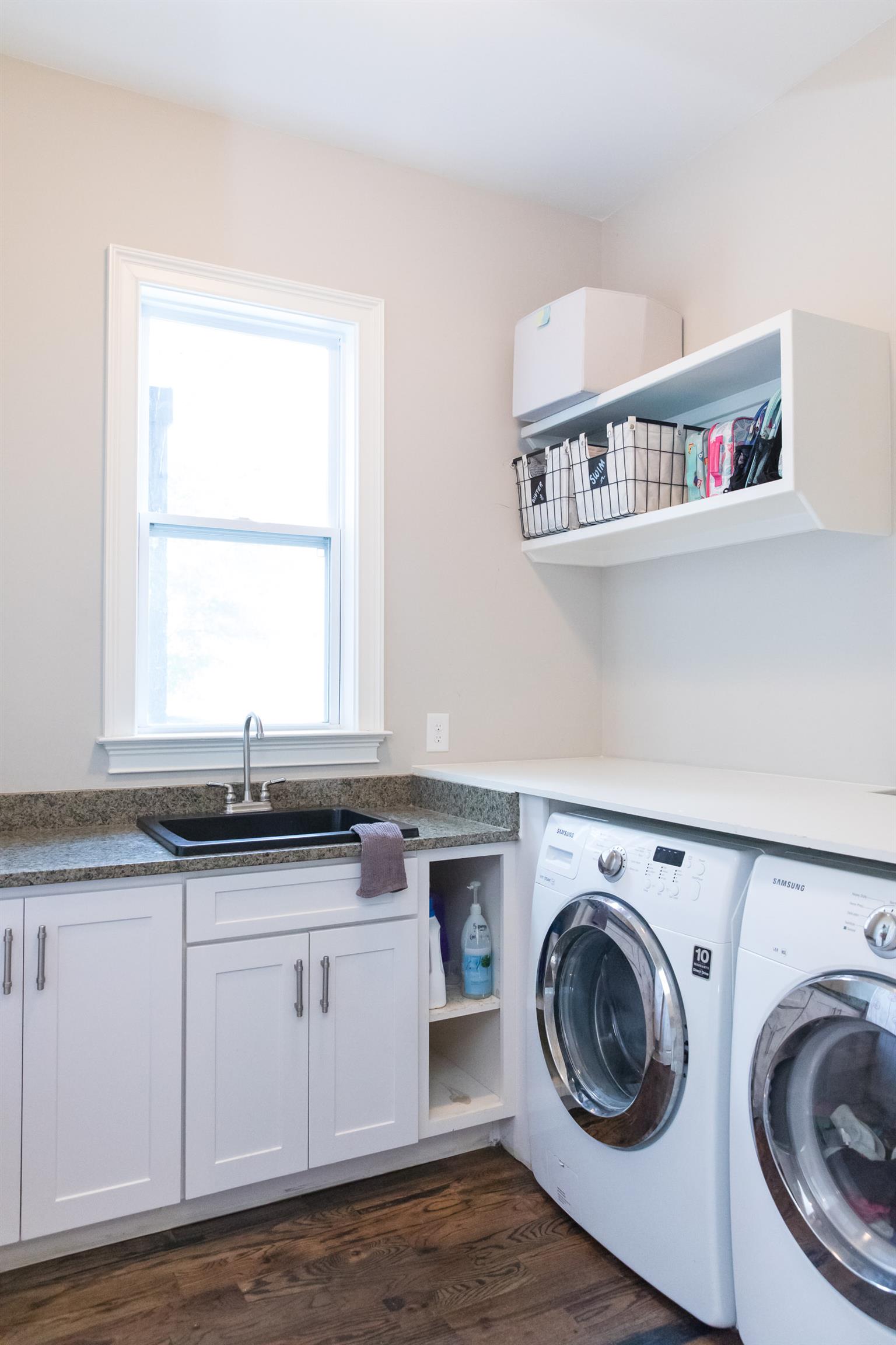 4309 Gallant Ridge Drive Franklin, TN 37064 - Photo 23 of 30 Laundry room with smart storage, basin sink with picture window outside, washer/dryer negotiable but perfectly fit the space... Not shown, there is a laundry shoot accessible from the upstairs bonus room!