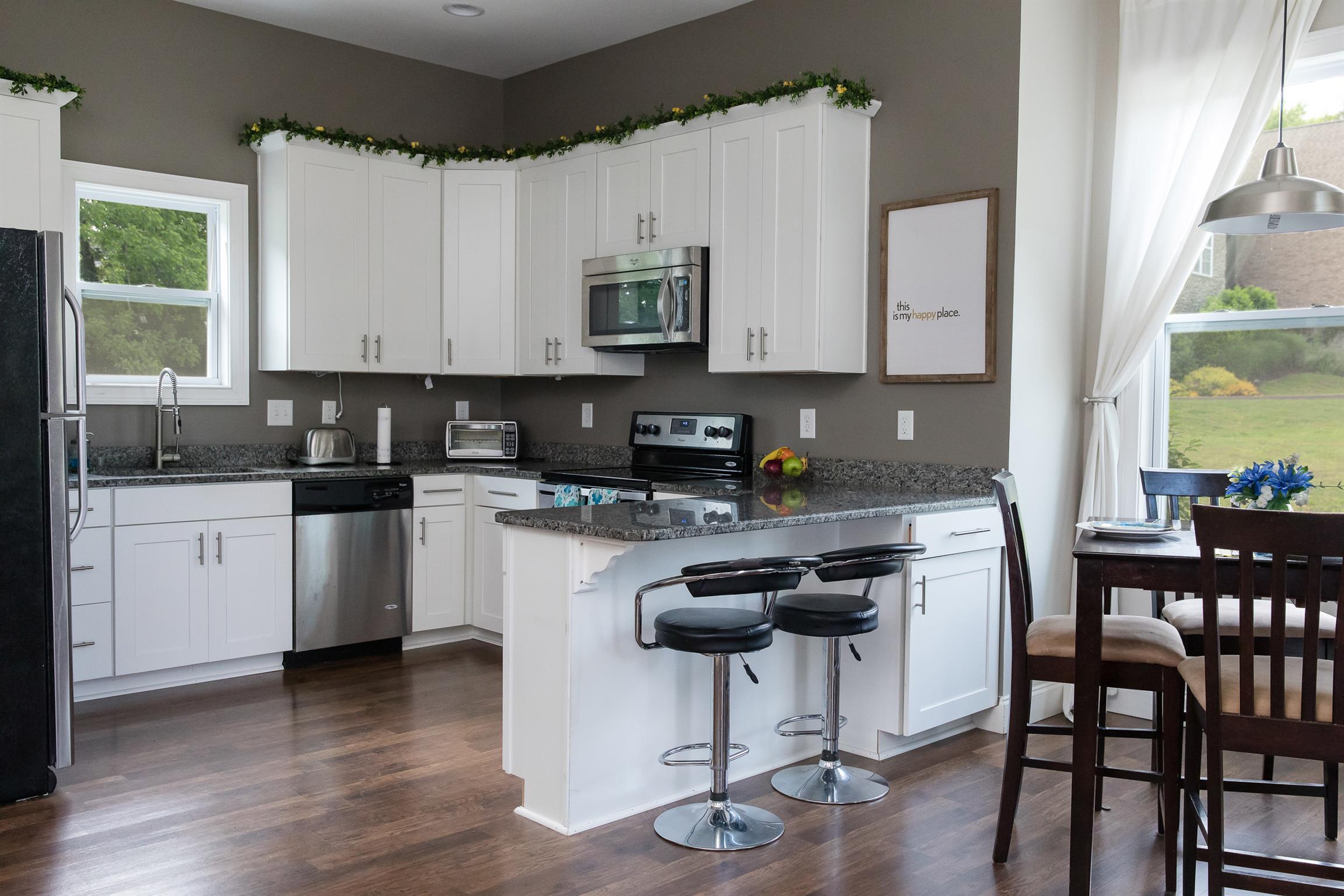 4309 Gallant Ridge Drive Franklin, TN 37064 - Photo 26 of 30 FULL Kitchen with granite counters, TONS of cabinet space, sink w picture window, built-in microwave, stainless range/oven, dishwasher, bar seating... Perfect for in-laws, teens, or a more private guest quarters!