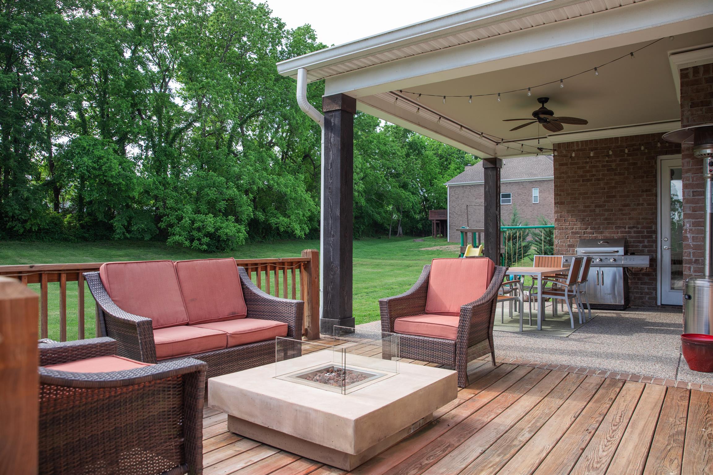 4309 Gallant Ridge Drive Franklin, TN 37064 - Photo 29 of 30 Covered back patio and open deck space for hangouts or cookouts. Direct gas line to grill on the patio. Restoration Hardware Fire table stays with the home!