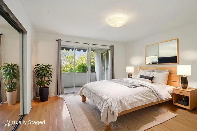 a bedroom with a bed and a potted plant