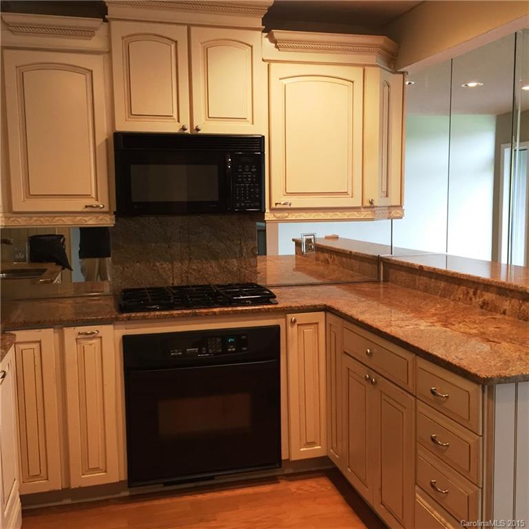 53 Old Post Road, Unit 53 Lake Wylie, SC 29710 - Photo 3 of 12 a kitchen with granite countertop cabinets stainless steel appliances and a sink