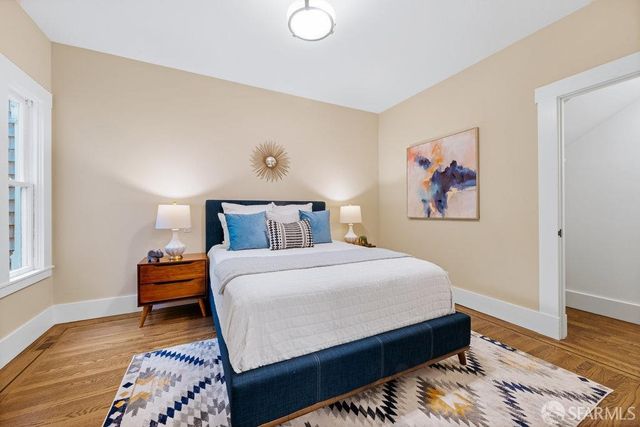 a bedroom with bed and cupboard