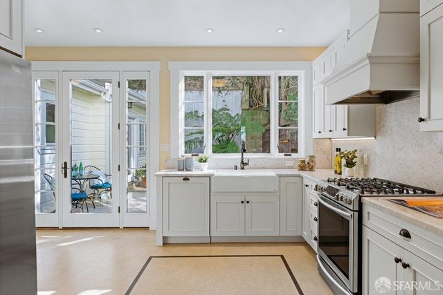 a kitchen with a sink stove and cabinets
