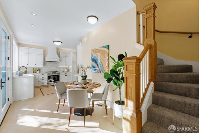 a dining room with furniture and a floor to ceiling window