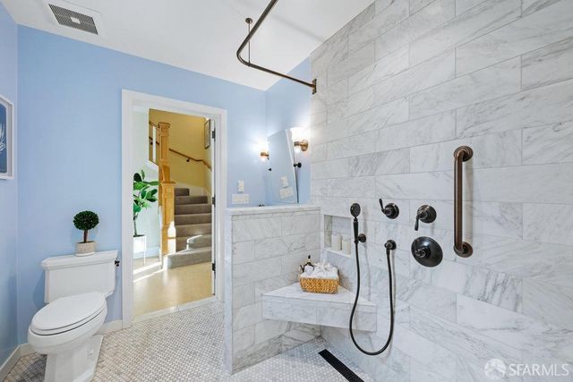 a bathroom with a toilet and a shower