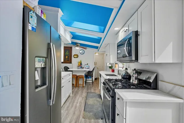 a kitchen with stainless steel appliances a white stove top oven and a refrigerator