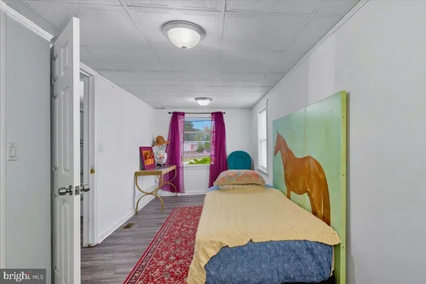 a bed room with a bed and a painting