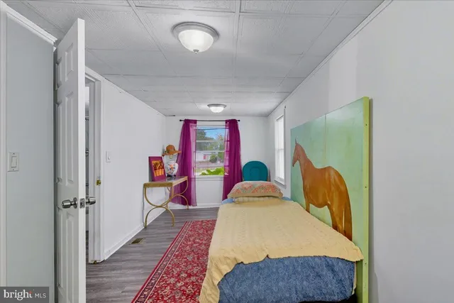 a bed room with a bed and a painting