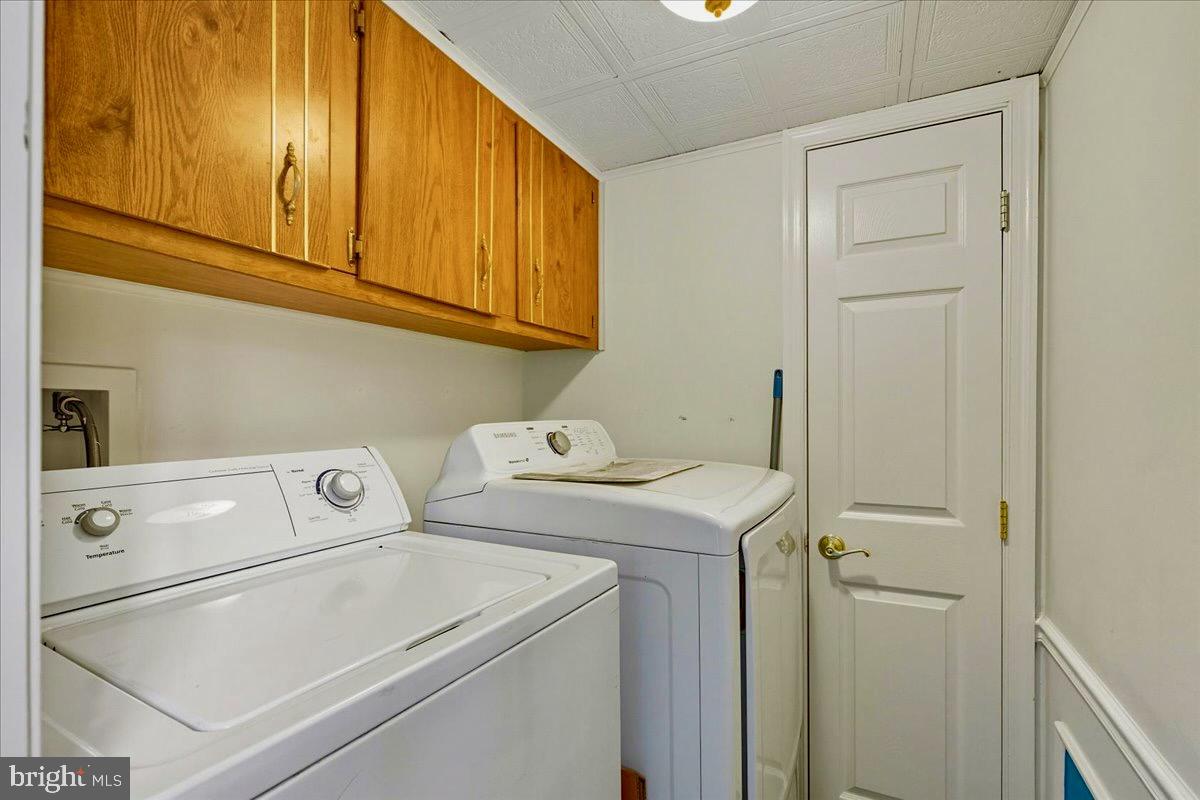 76 Patuxent Mobile Estates Lothian, MD 20711 - Photo 14 of 21 Dedicated laundry space featuring storage.