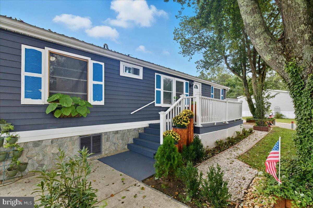 76 Patuxent Mobile Estates Lothian, MD 20711 - Photo 2 of 21 Generous front deck adds great curb appeal and out