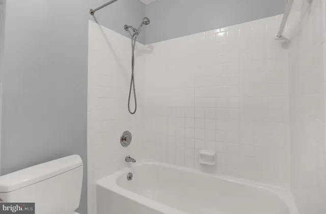 a bathroom with a bathtub and a toilet