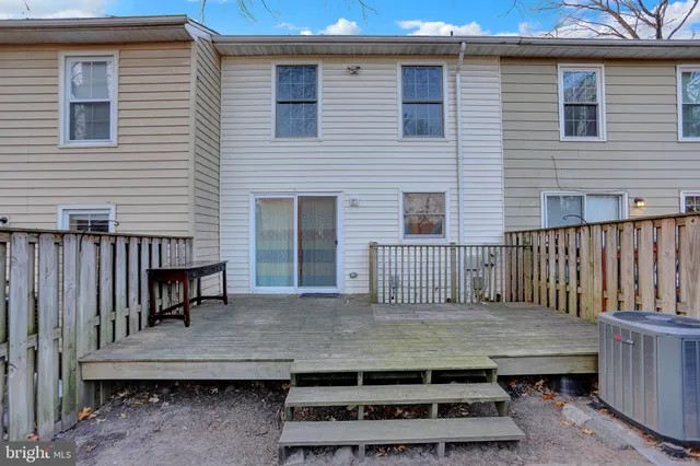 a view of a roof deck with wooden fence