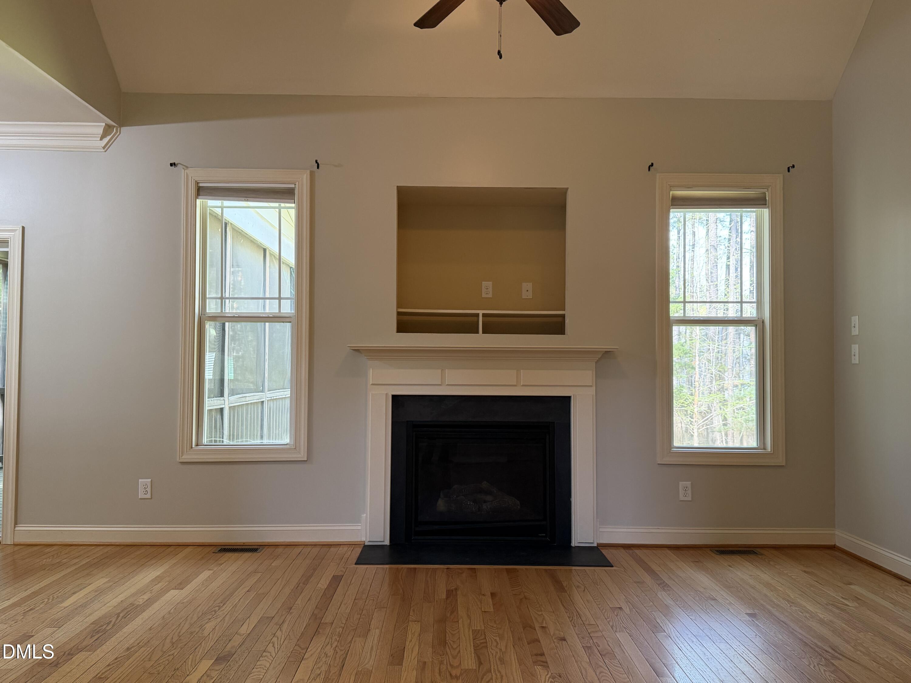 204 Blair Hills Road Wendell, NC 27591 - Photo 14 of 52 a view of an empty room with wooden floor fireplace and a window
