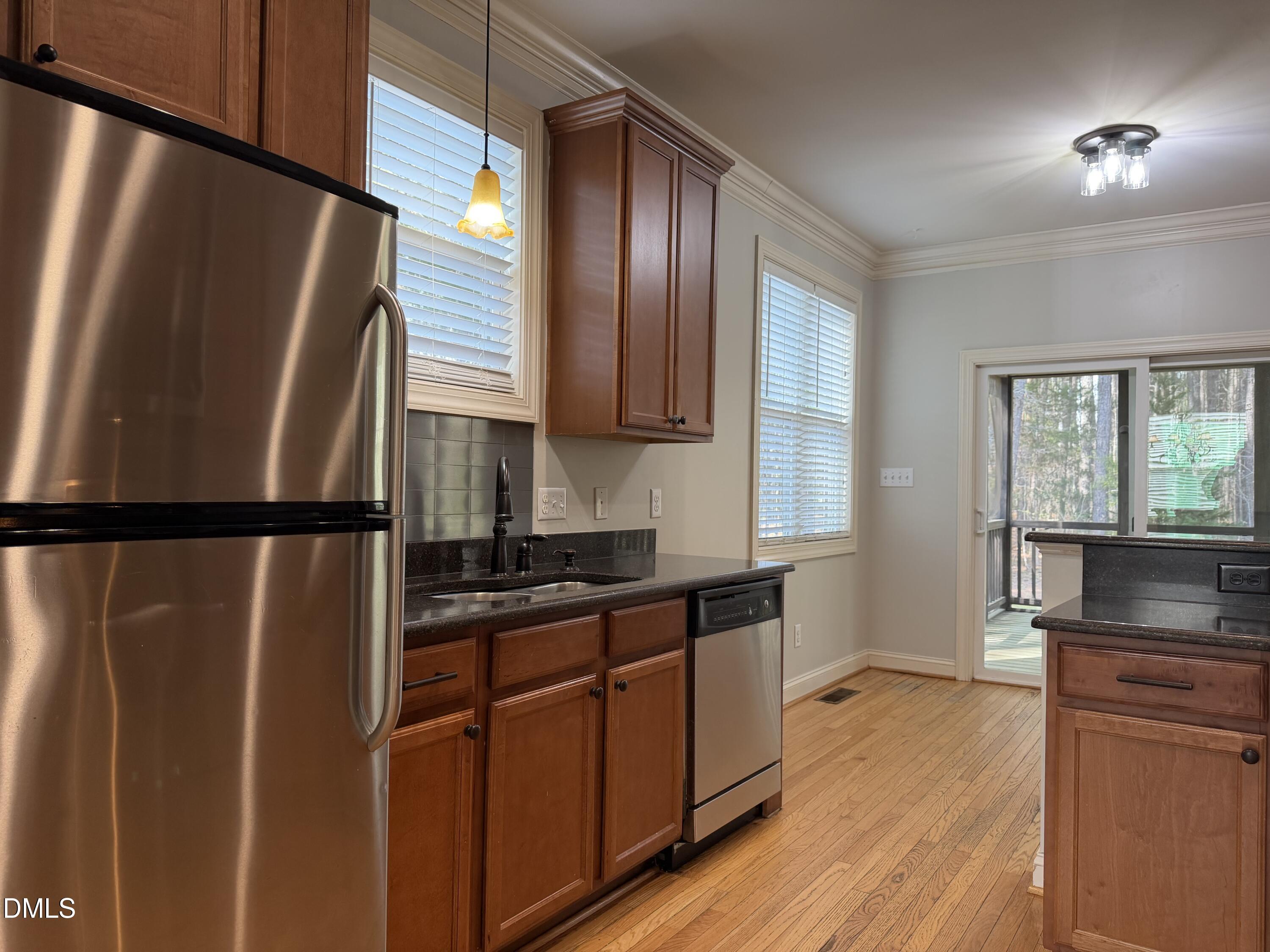 204 Blair Hills Road Wendell, NC 27591 - Photo 17 of 52 a kitchen with granite countertop stainless steel appliances a refrigerator a sink a stove a refrigerator wooden floor and cabinets