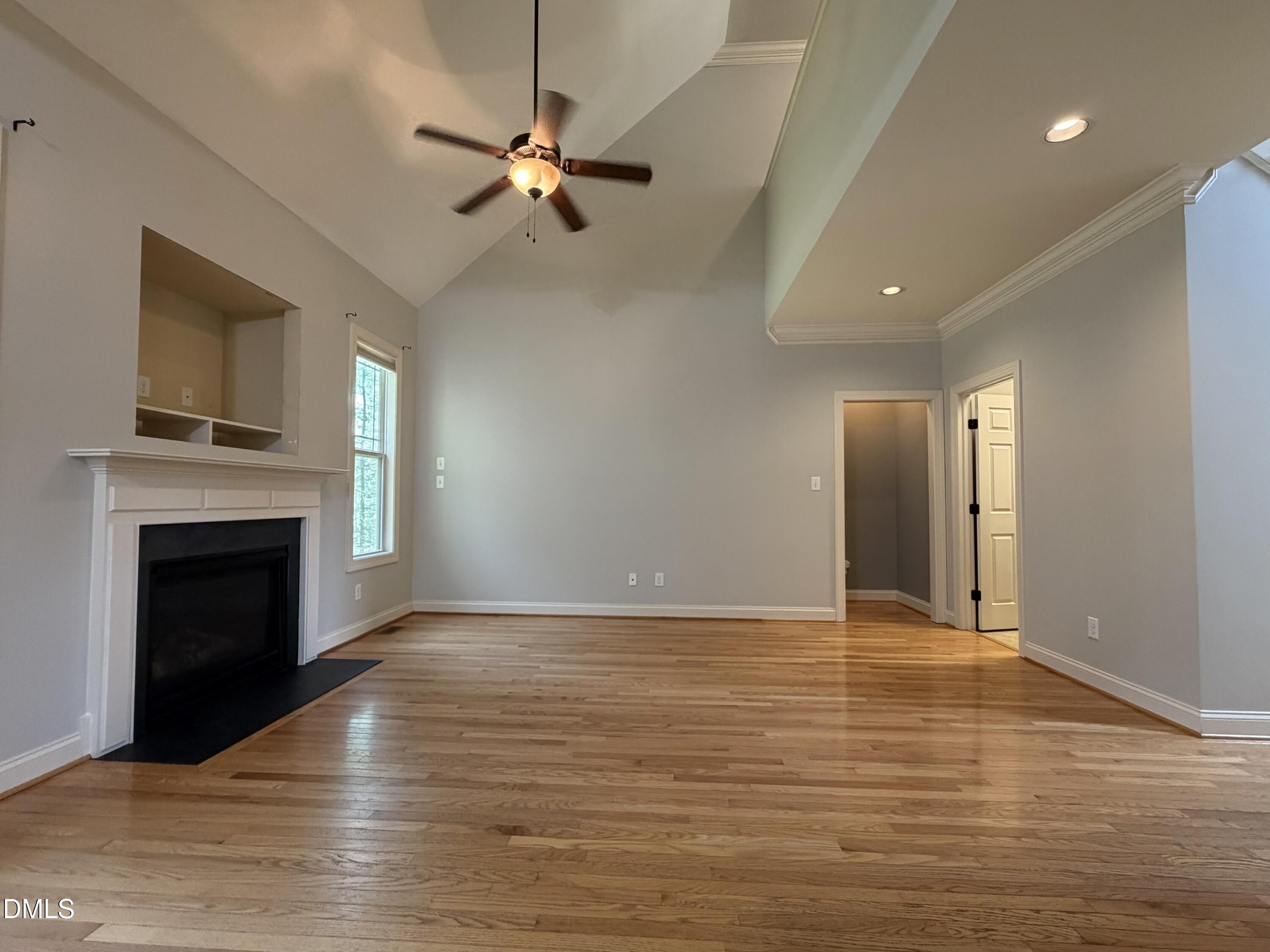 204 Blair Hills Road Wendell, NC 27591 - Photo 20 of 52 a view of an empty room with wooden floor fireplace and a window