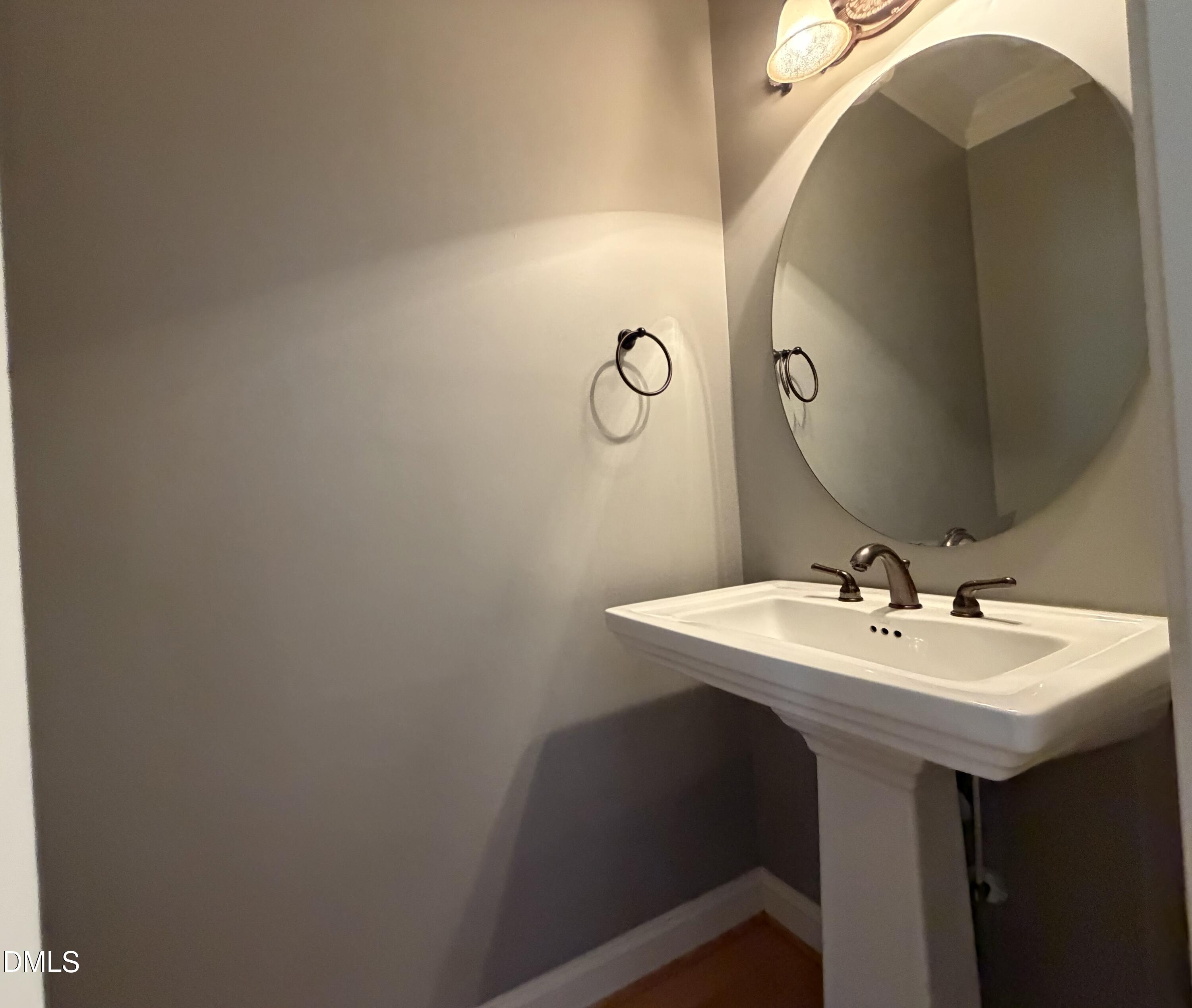 204 Blair Hills Road Wendell, NC 27591 - Photo 21 of 52 a bathroom with a sink and mirror