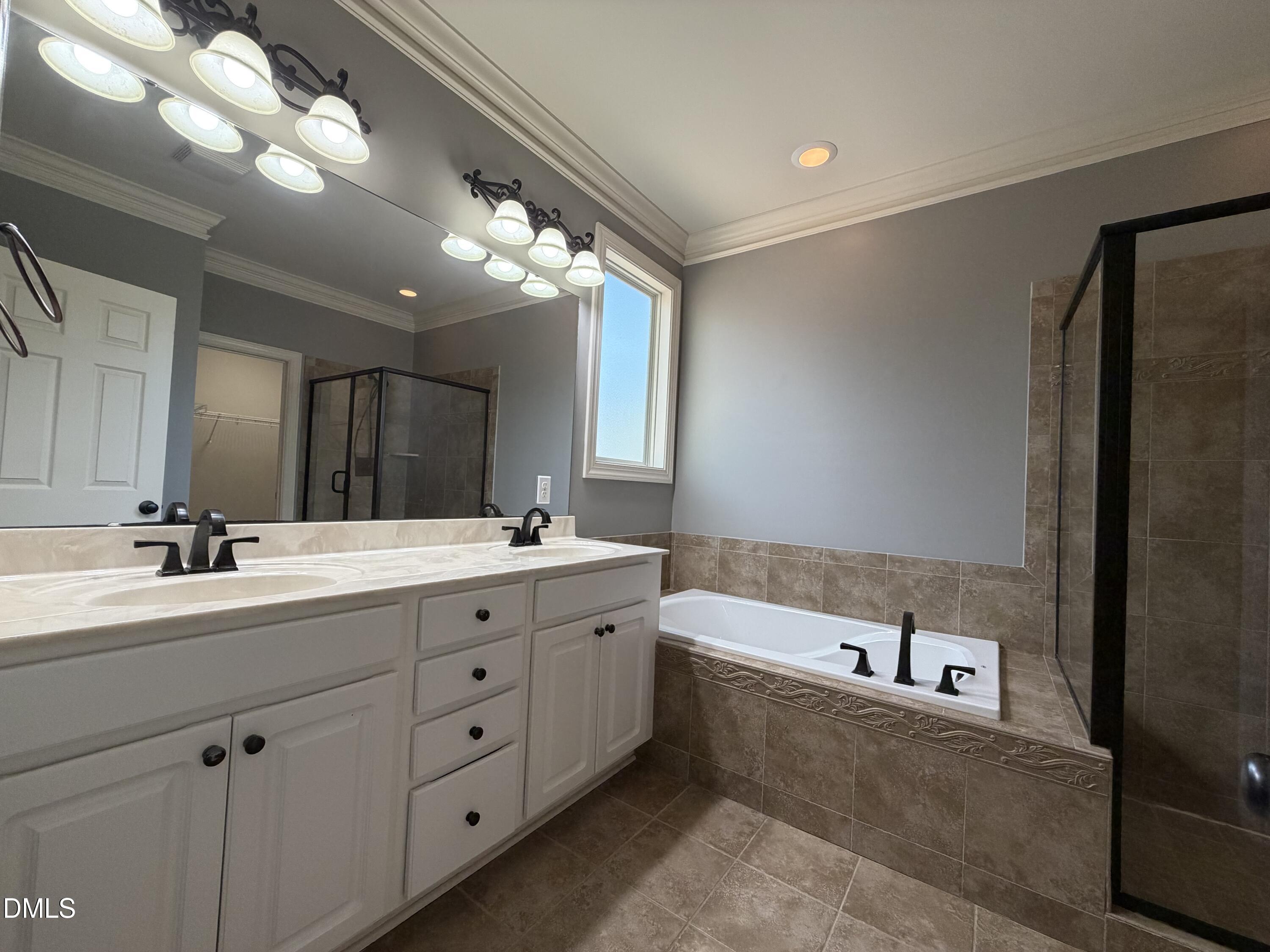 204 Blair Hills Road Wendell, NC 27591 - Photo 25 of 52 a spacious bathroom with a tub sink and mirror
