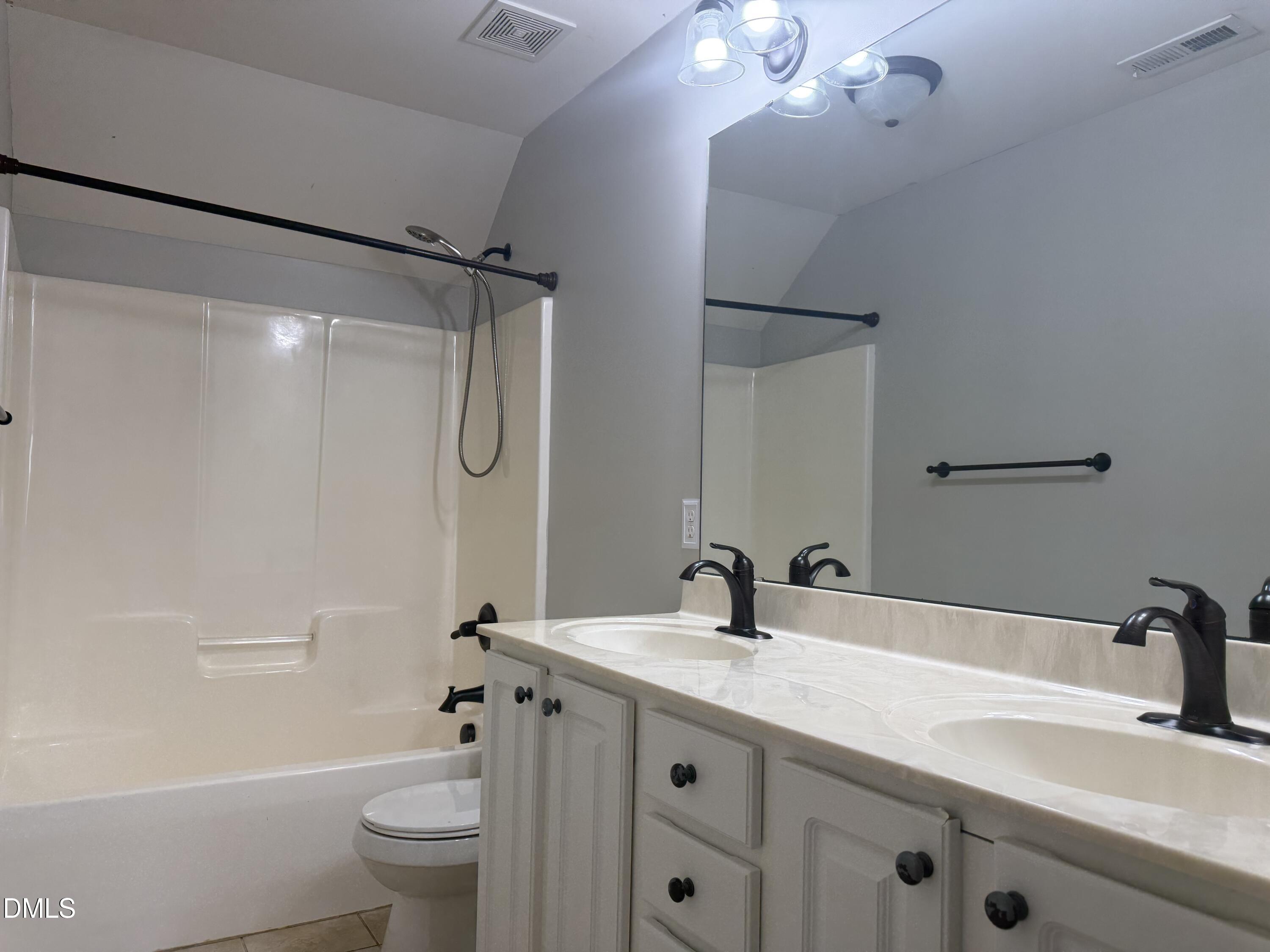 204 Blair Hills Road Wendell, NC 27591 - Photo 40 of 52 a bathroom with a double vanity sink toilet mirror and shower