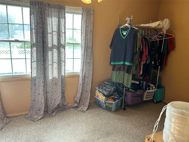 a view of room with gym equipment and windows