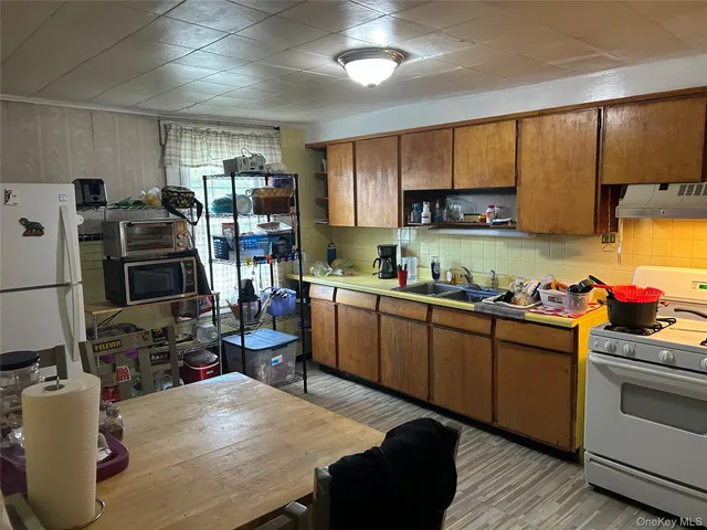 a kitchen with sink cabinets and wooden floor