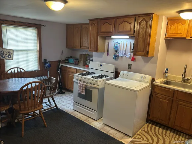 a kitchen that has a sink and chair