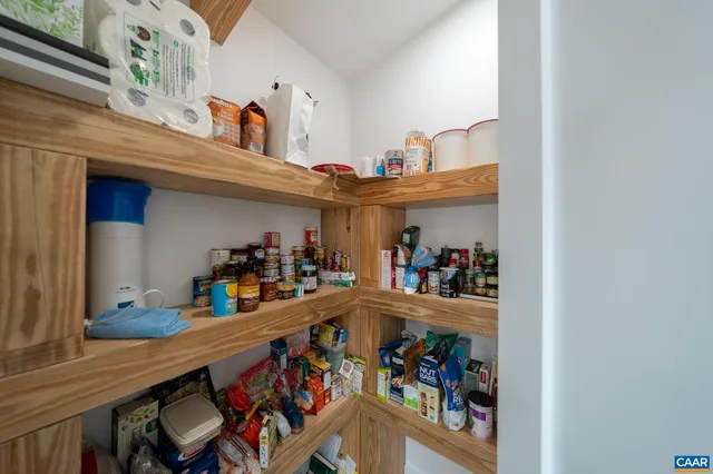 a bedroom with a bed and a flat tv screen on the dresser