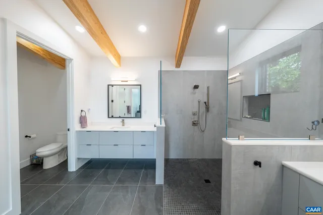 a bathroom with a sink mirror and a bathtub