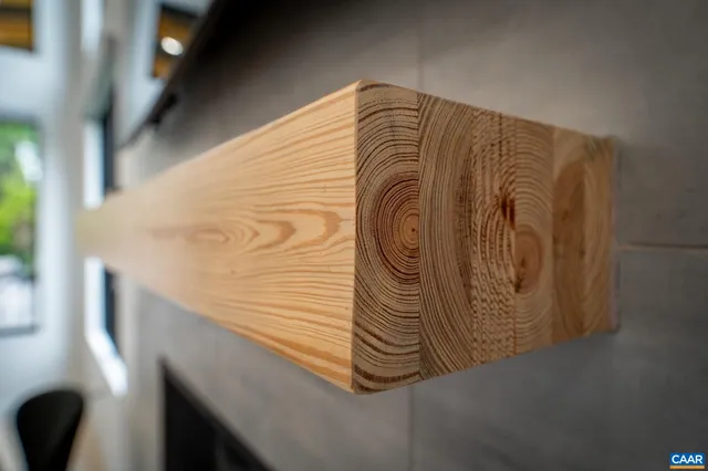 a living room with furniture fireplace and a large window