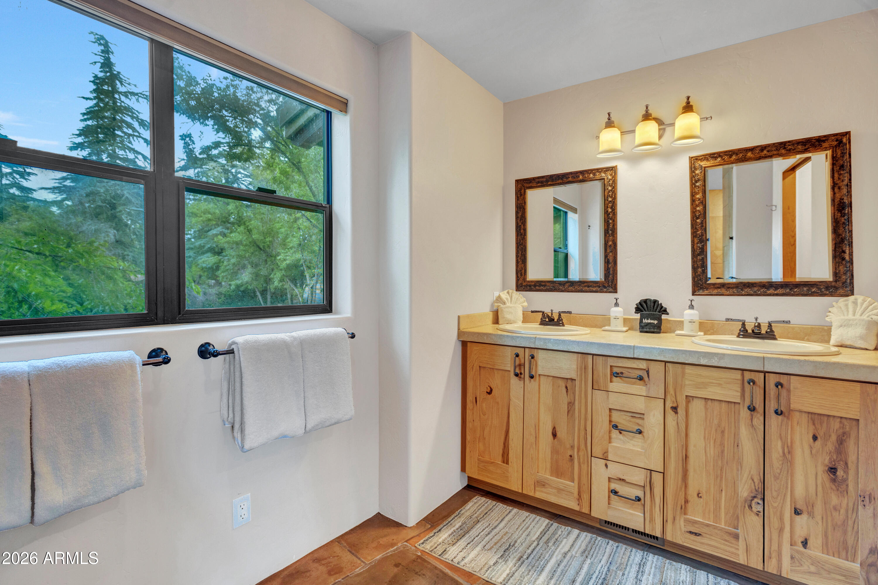 55 Ranch House Circle Sedona, AZ 86336 - Photo 51 of 61 a spacious bathroom with a double vanity sink a mirror and a window