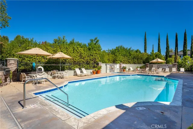 a room with gym equipment and wooden floor